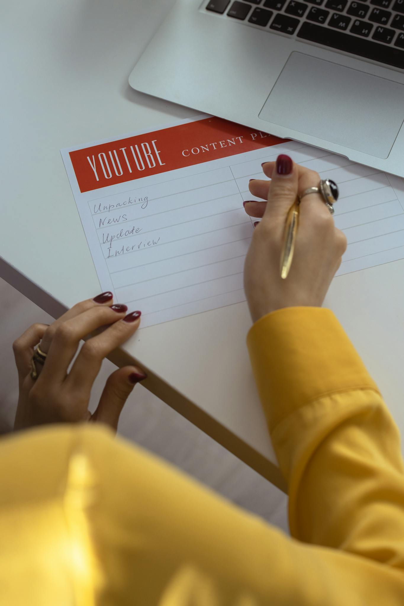 About 4 woman with manicured nails writes youtube content