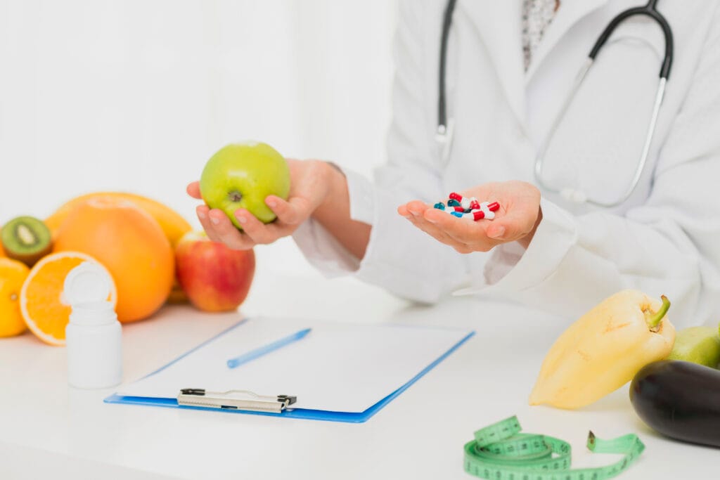 How Vitamin Supplements Work in the Body 2 Vitamin supplements and nutrient-rich foods arranged on a table